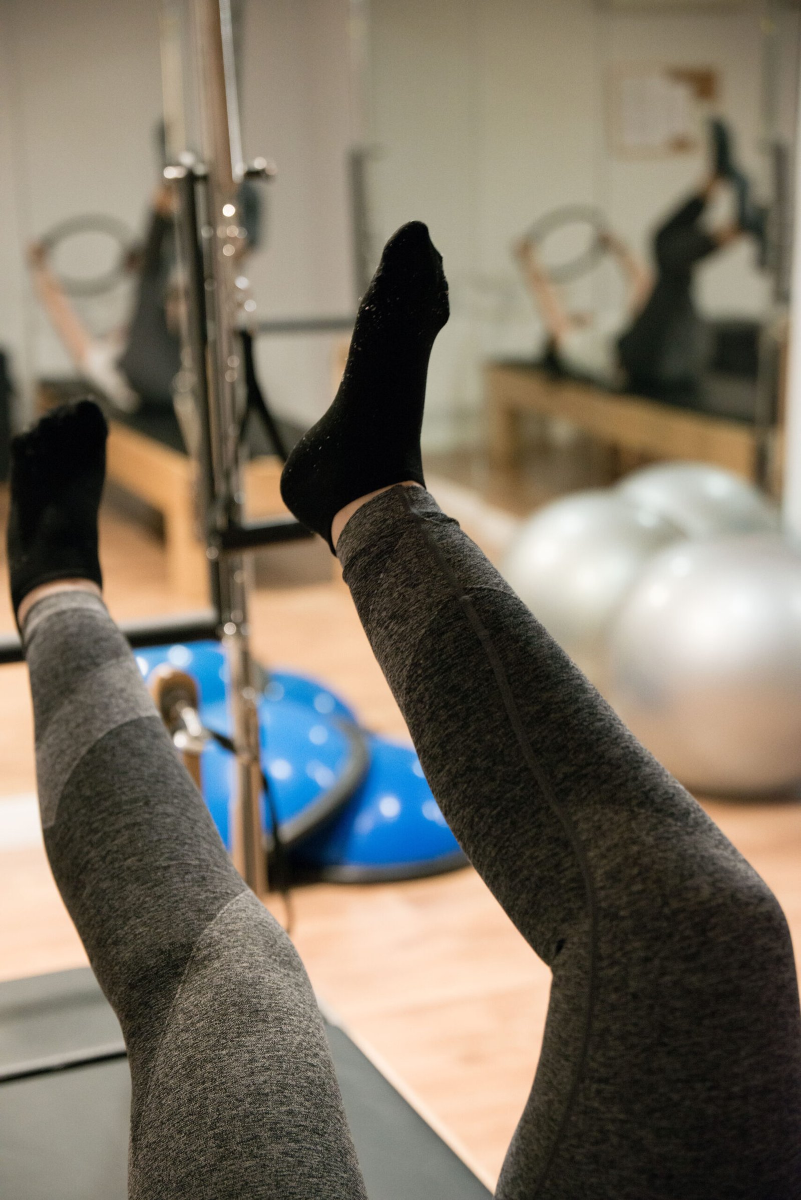 Woman doing exercises with reformer machine. Streching